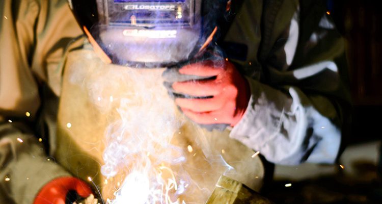unrecognizable-person-wearing-a-helmet-and-welding-GT22LPJ.jpg